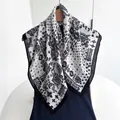 Detail of vintage paisley pattern on black and white cotton linen square scarf on a hanger - White Black Paisley Style (Style 23)