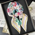 Detail of floral print silk scarf tied in a bow on a vintage display tray - Purple Yellow Border Multicolor Floral Style (25)