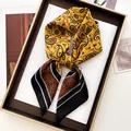 Elegant silk scarf with yellow paisley floral patterns and black striped accents in a gift box - Yellow