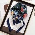Floral butterfly silk scarf in navy blue and white, elegant knotted style on a tray - Dark Blue