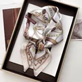 Elegant white silk scarf with gold chain and equestrian print on a display tray - Khaki