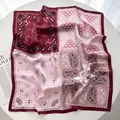 Detailed view of paisley and geometric pattern silk scarf in burgundy and pink tones - Red