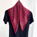 Close-up of wine red polka dot cotton linen square scarf with paisley floral border - Red