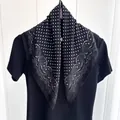 Detail of a chic cotton-linen scarf with white polka dots and paisley patterns on black fabric - Black