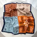 Detail of soft faux silk scarf featuring colorful paisley prints and geometric patterns - Navy Blue