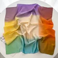 Detail of colorful gradient silk-like square scarf draped over a magazine - Violet