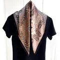 Detailed shot of paisley print silk scarf with Eiffel Tower icons and satin finish - Black and Gray