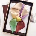 Close-up of multicolor silk scarf showing elegant drape and smooth satin texture on a tray - Soft Gradient (13)