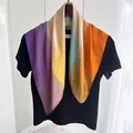 Close-up of lightweight silk-like scarf with vibrant gradient colors and rolled edges - Bright yellow