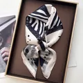 Elegant black and white zebra print silk square scarf with abstract patterns on a tray - Zebra Beige
