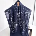 Navy blue paisley printed scarf with white star patterns on a wooden hanger - Dark Blue