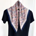 Detail of vintage paisley silk scarf with dark blue border draped over a black t-shirt - Navy Red Orange Paisley Style (Style 3)
