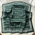 Detailed close-up of dark green paisley silk scarf with white border on a round table - Dark Green White Paisley (3)
