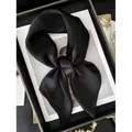Elegant black silk satin square scarf tied in a bow on a vintage gold tray - Black