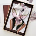 Detail of a paisley silk scarf tied in a bow inside a premium gift box with soft lighting - Luxury Chain Contrast (16)