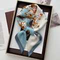 Elegant floral silk square scarf with blue and orange prints displayed on a premium tray - Sky Blue
