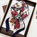 Close-up of floral satin scarf with red lilies and navy blue border on a tray - Navy Border Red Yellow Lily Style (19)