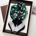 Detail of silk-like scarf featuring white lily of the valley print on navy blue background - Grass Green Blue White Lily Of Valley Style (15)