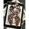Chic leopard print silk scarf with brown border displayed on a fashion magazine - Coffee Border Leopard Print