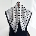 Detail of a large square polka dot scarf with black border on a wooden hanger - White Black Polka Dot Border Style (Style 8)