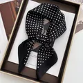 Close-up of a black and white polka dot silk scarf tied in a stylish knot inside a gift box - Black / Black and White Polka Dot Style (1)