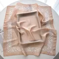 Detail of soft pink silk square scarf with white floral border and plaid pattern - Khaki