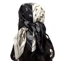 Dettaglio di un foulard in raso bianco e nero con stampa paisley sui capelli - Stile Paisley / Nero