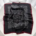 Detail of vintage French silk scarf with paisley pattern and polka dots on white surface - Black Red