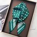 Elegant green silk scarf with white polka dots and diagonal stripes on a display tray - 3-Sided Polka Dot Green