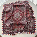 Detailed flat lay of a silk paisley square scarf with vintage red and navy mandala patterns - Red