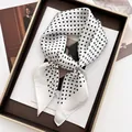 Detail of silk-textured white square scarf with black polka dots tied in an elegant bow - White / White Polka Dot Style (3)