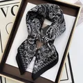 Premium black and white paisley silk scarf tied in a bow on an elegant display tray - Black and White Vintage Paisley Style (13)