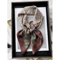 Vintage paisley print square satin scarf in brown and blue, tied for stylish display - Reddish Brown