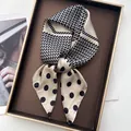 French style polka dot silk scarf with black and beige geometric pattern on display - Rectangular Khaki
