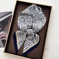 Navy and cream geometric wave pattern silk square scarf tied in a luxury display - Navy Simple Semicircle Wave Style (12)
