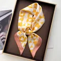 Square silk scarf with yellow and white geometric patterns and pink border in a gift box - Ring Orange