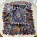 Detailed view of large satin square scarf featuring blue and orange paisley patterns - Dark Blue