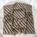 Detailed view of square silk scarf with vintage equestrian horse motifs and yellow stripes - Khaki