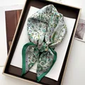 Macro detail of silk scarf featuring paisley floral patterns in a luxury display box - Paisley Floral (8) / Verdant