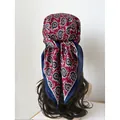 Women's paisley headscarf in wine red and blue tied on hair for elegant styling - Burgundy Paisley Pattern on Blue Base (Style 11)