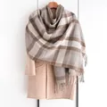 Close-up detail of soft plaid scarf with tassels in coffee brown and beige tones - Khaki