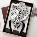 Classic black and white polka dot silk scarf tied in a bow on a luxury gold tray - Black White Polka Dot Black Wide Border Bow Style (8)