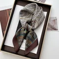 Brown and blue paisley silk scarf styled with a knot on a decorative tray - Dark Brown Wide Edge Paisley Style (17)