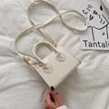 Piccola borsa quadrata bianco crema minimalista con manici e dettagli dorati - Bianco