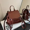 Mini vintage dark brown leather backpack with drawstring and flap closure on books - Coffee