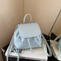 Light blue minimalist faux leather mini backpack with min embossing and drawstring - Creamy Blue