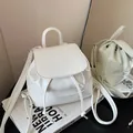 Mini white leather backpack with mim logo and drawstring closure shown with mirror reflection - White