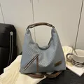 Light blue woven tote bag with brown leather handles and decorative zipper detail - Blue