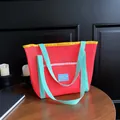 Red mesh tote bag with yellow trim and mint green straps for beach or shopping use - Orange Red