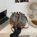 Gray denim and brown leather drawstring bucket bag with dual front utility pockets - Black Without Charm